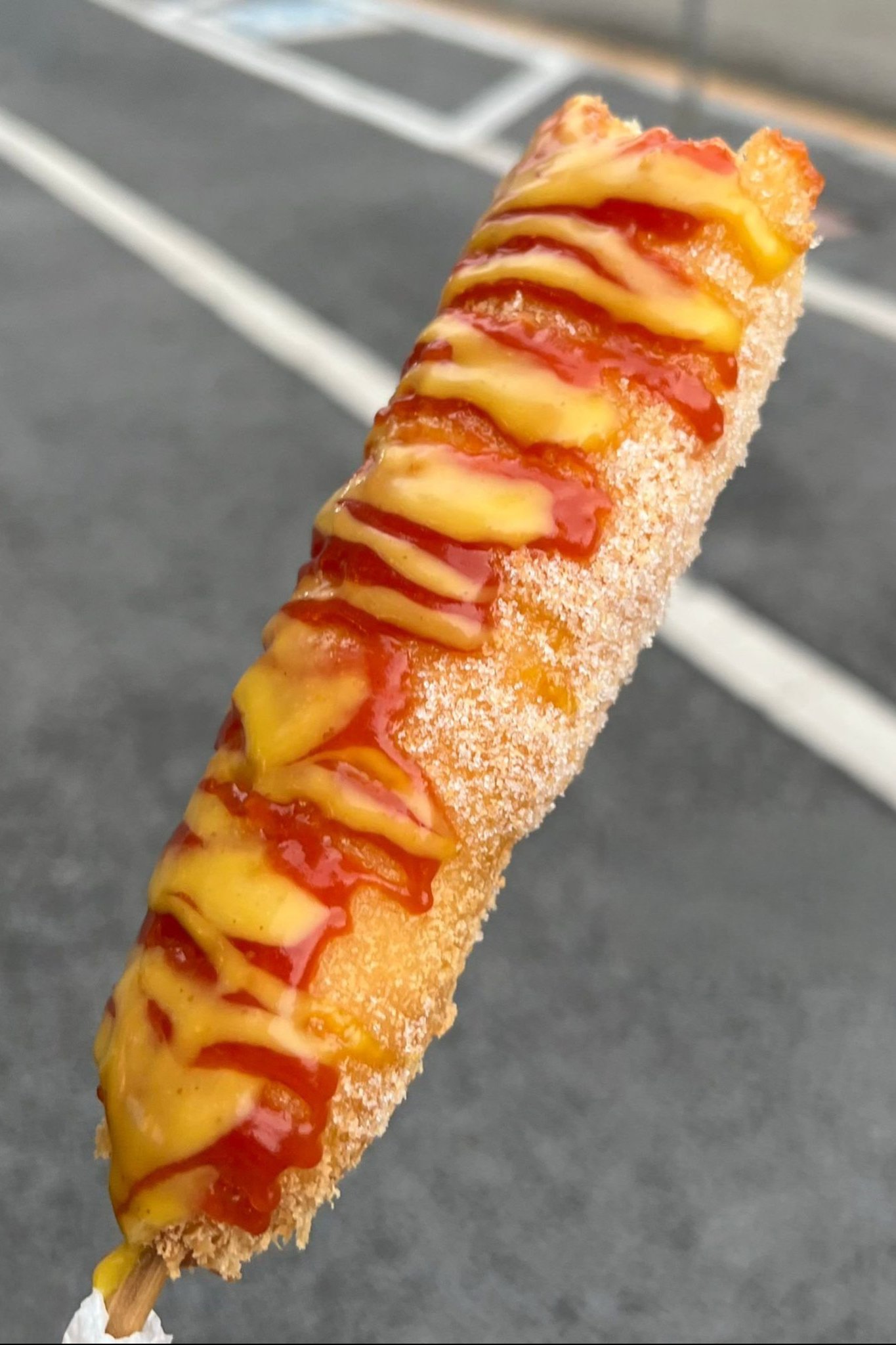 Elote on a stick with cheese, lime, and chili