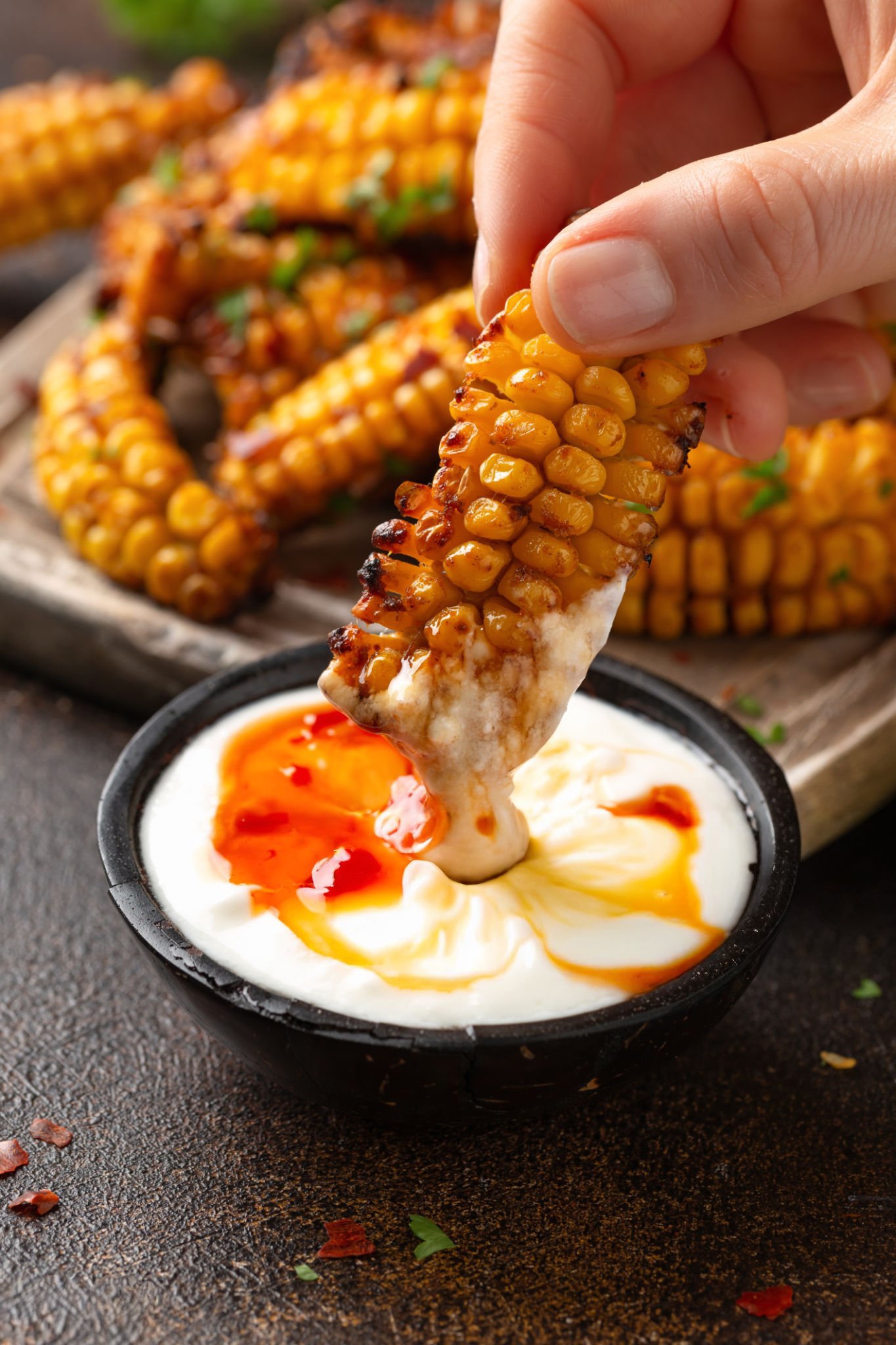 Elote on a stick with cheese, lime, and chili