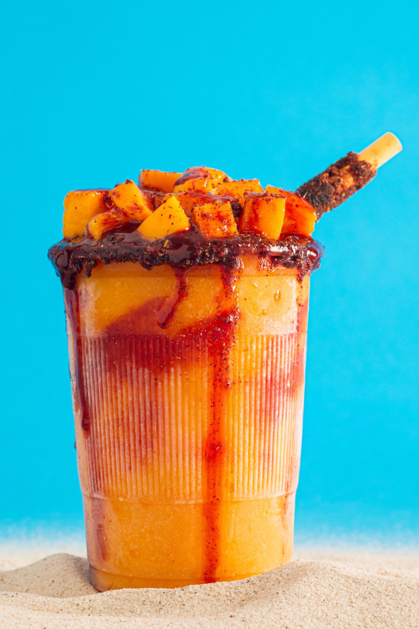 Elote on a stick with cheese, lime, and chili